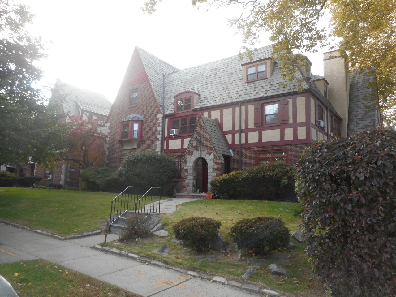 Tudor-style apartment buildings and landscaped front lawns in Bayside, Queens.