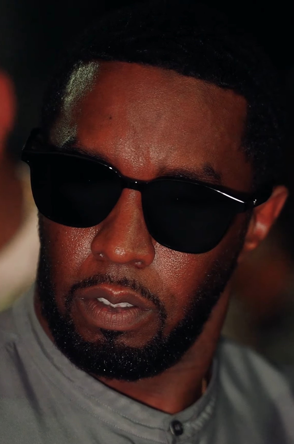 Sean Combs wearing dark sunglasses in a close-up from a 2023 interview.
