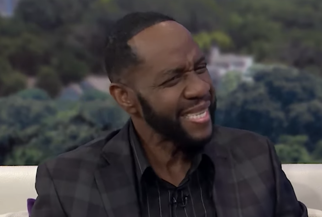 Freddie Jackson smiling in a black suit during a 2019 Sister Circle TV interview.