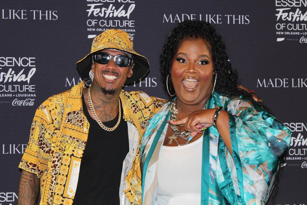 Nick Cannon and Courtney Bee posing together at Essence Festival of Culture in 2025