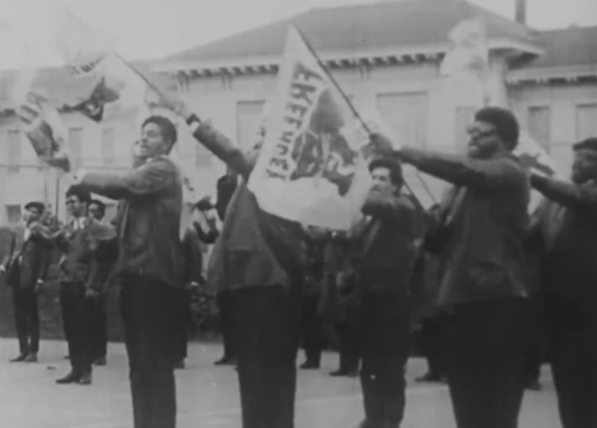 Students carrying Black Panther Party flags during an archival protest in Oakland