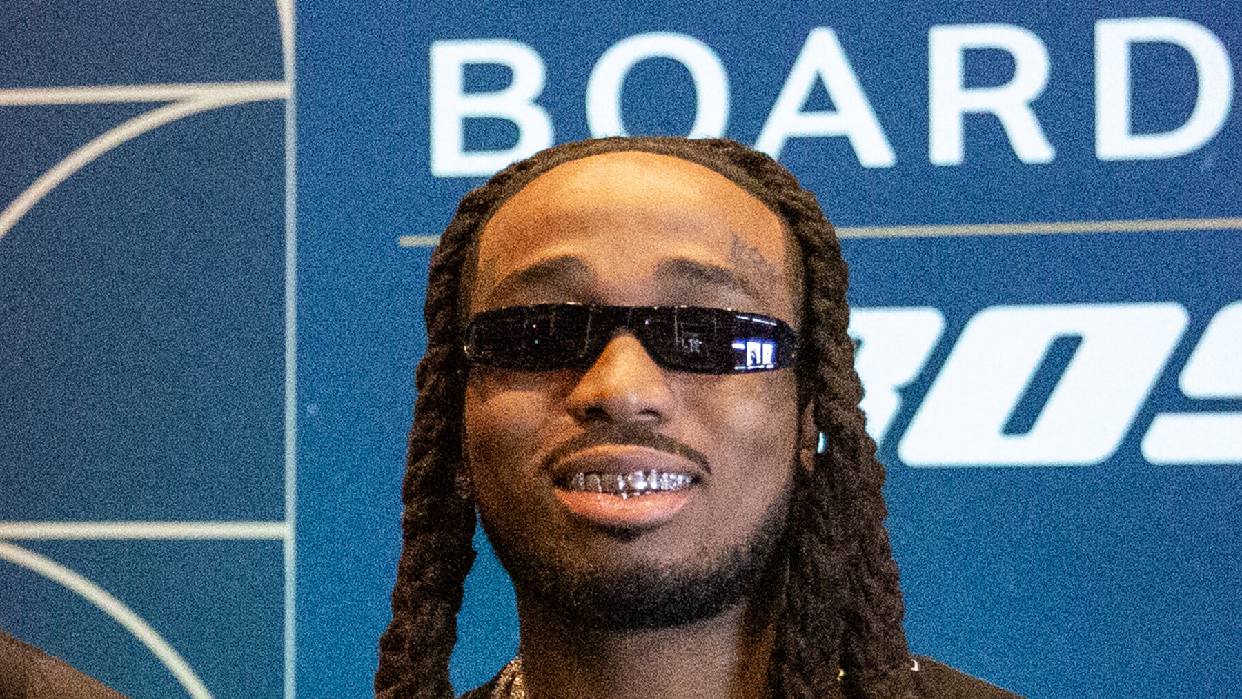 Quavo wearing sunglasses and jewelry at NBA All-Star Weekend in February 2025.