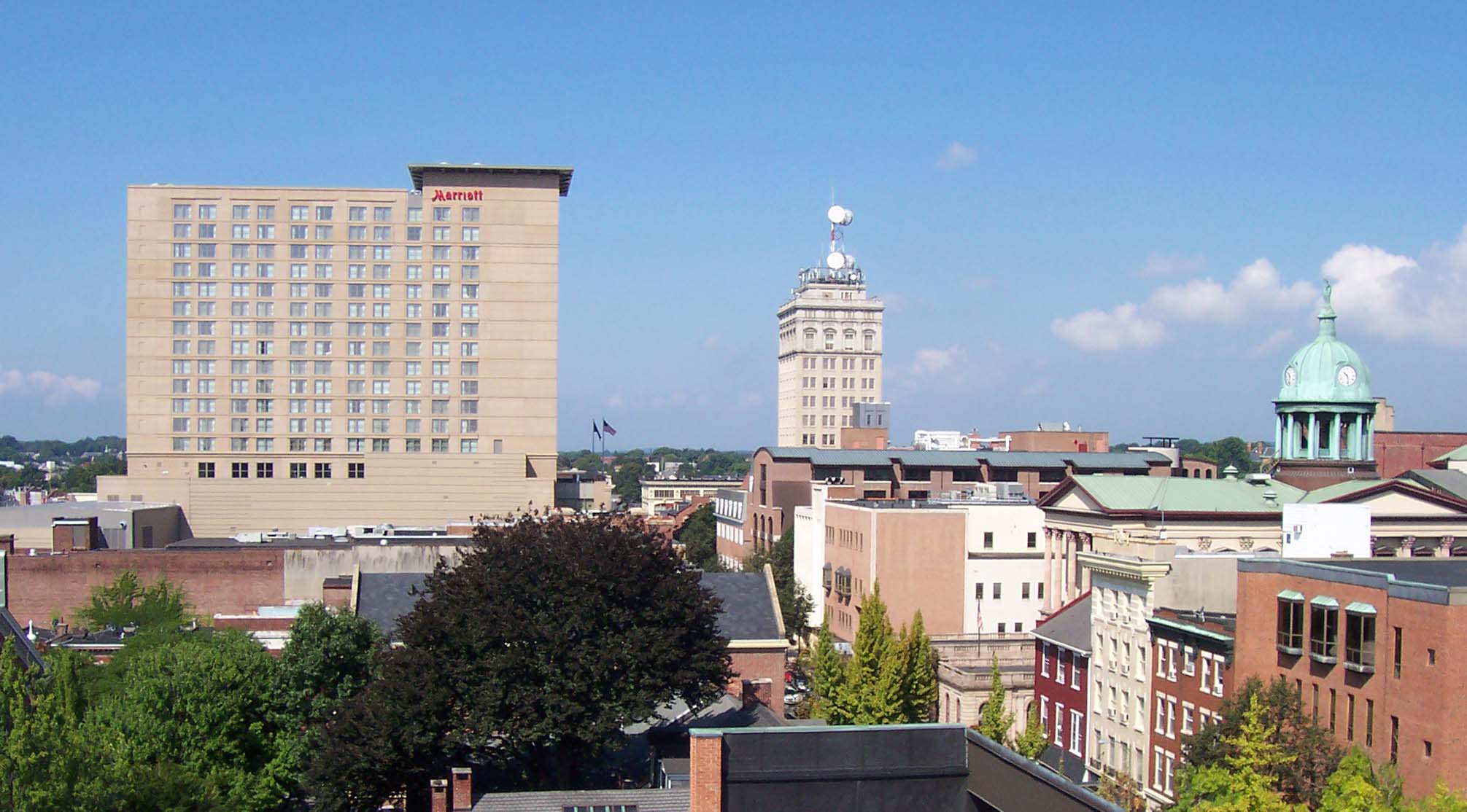 A daytime view across downtown Lancaster, Pennsylvania, under a clear blue sky.