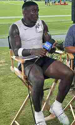 Tyreek Hill seated on a football practice field during a 2025 interview